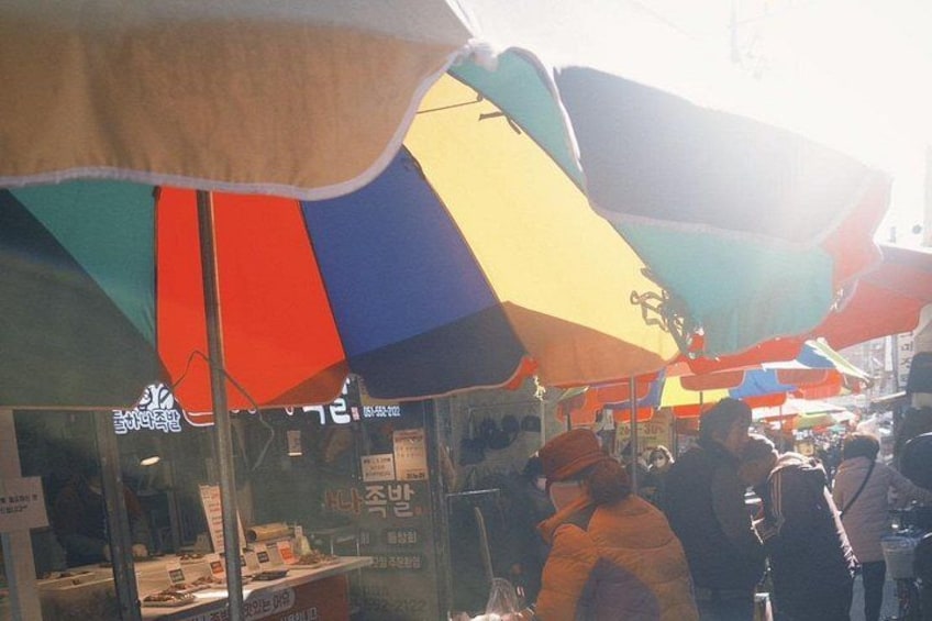 A market with colorful umbrellas and stalls. 5