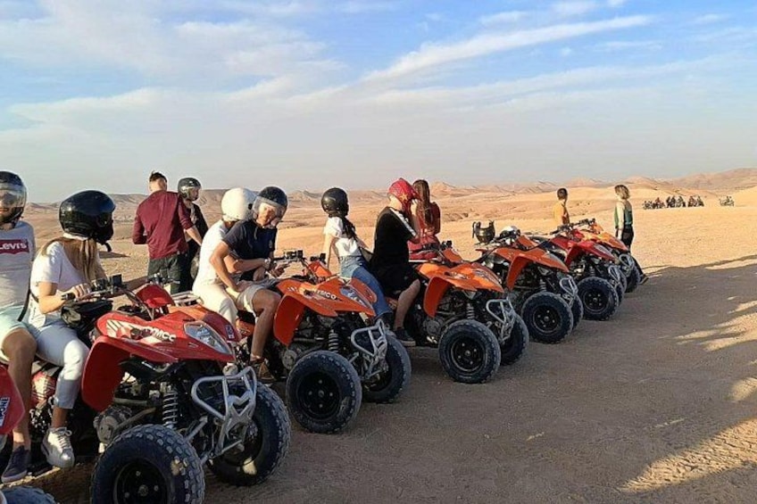 A group of people on ATVs in a desert landscape. 1
