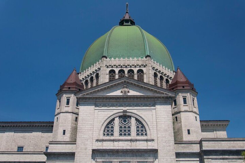 A large building with a green dome and arched windows. 1