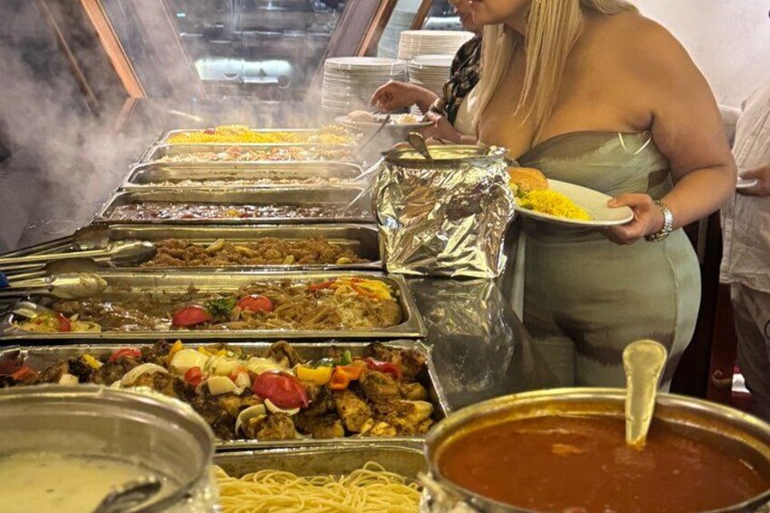 A buffet with various dishes, including pasta, meats, and vegetables. 5