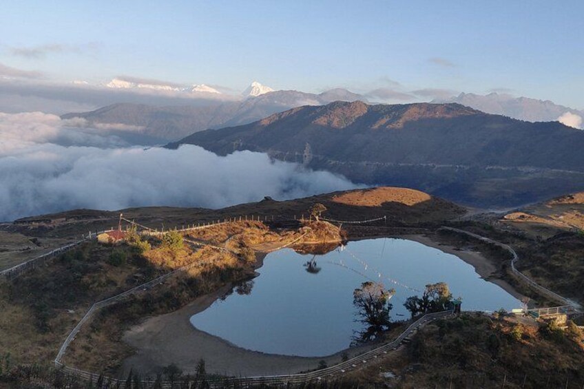 A mountainous landscape with a lake, a bridge, and a road. 3
