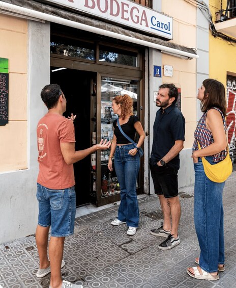 A group of people standing outside a store named 'BODEGA Carol'. 3