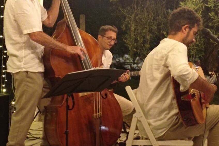 A group of musicians performing outdoors at night. 4