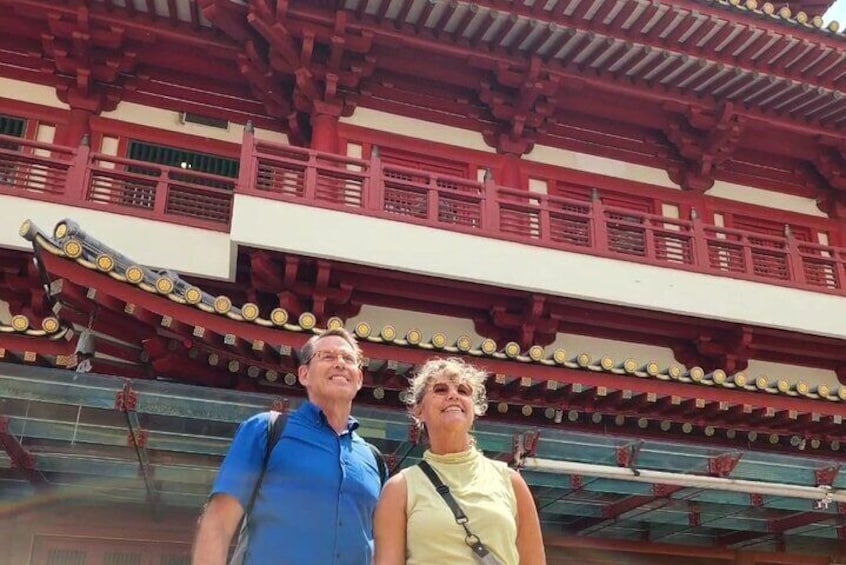 A traditional Japanese building with a red and white color scheme and a curved roof. 1