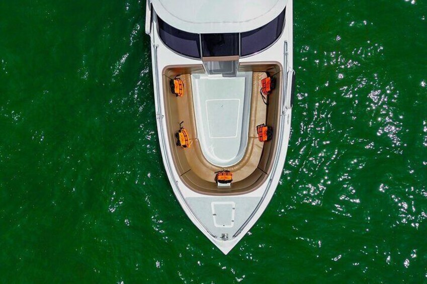 A white boat with a central seating area and four smaller boats around it. 4