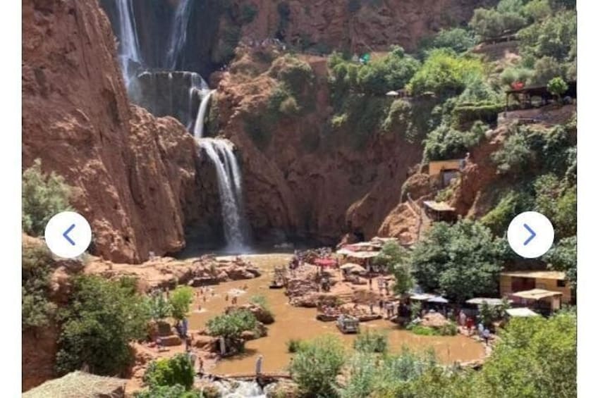 A waterfall, a river, and a settlement with buildings and trees. 2