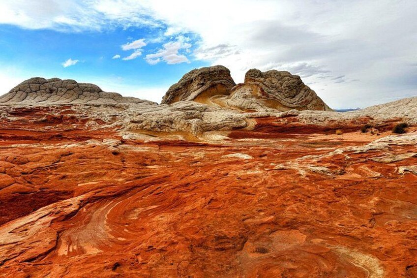 A desert landscape with red rock formations and a clear sky. 2