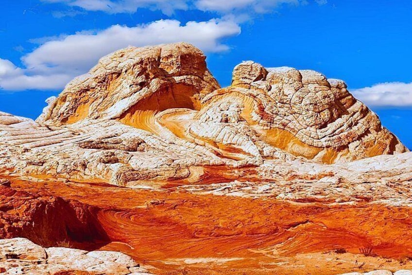 A rugged landscape with layered rock formations and a clear blue sky. 3