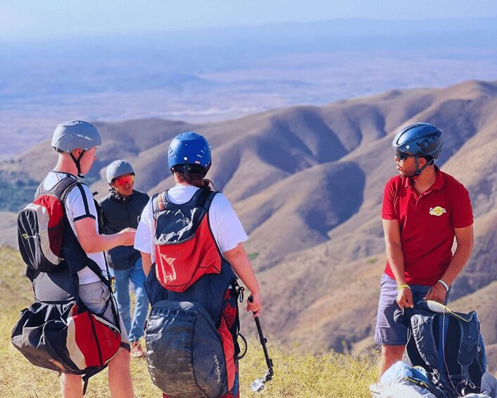 A group of hikers on a mountain trail with a panoramic view of the landscape. 4