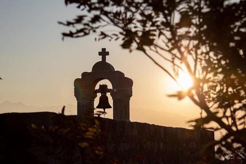 A church with a bell tower silhouetted against a sunset. 3