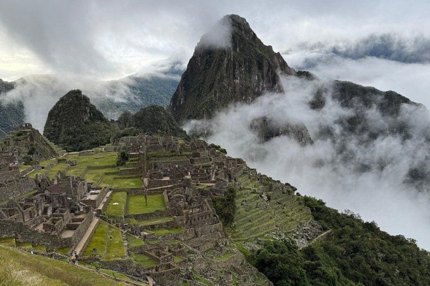 Machu Picchu, ancient Incan ruins, with cloud-covered mountains in the background. 1