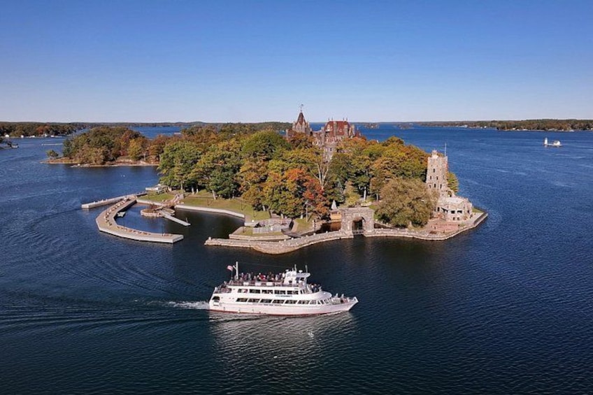 A river with a boat, a small island with a castle, and a bridge. 5
