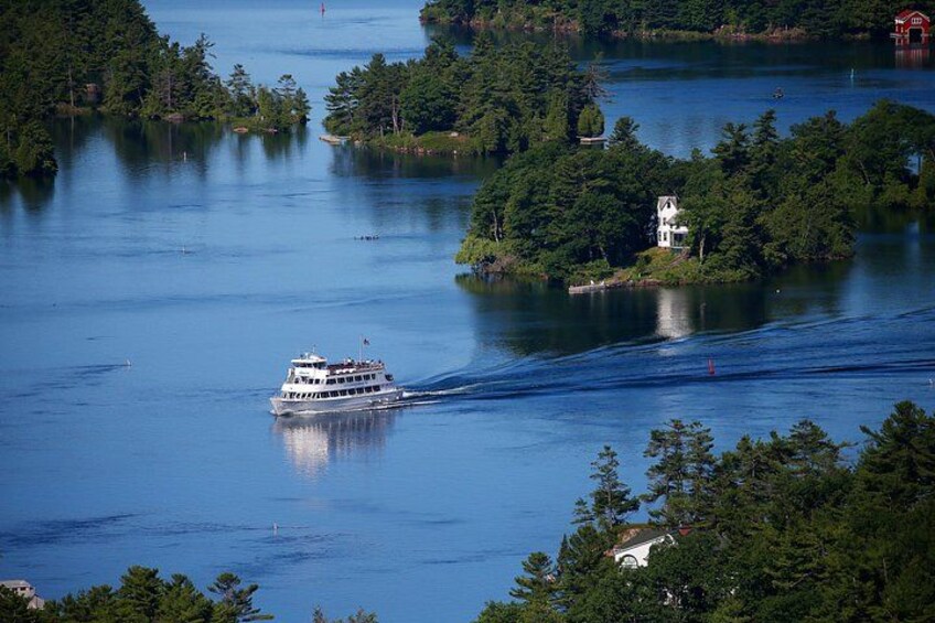A river with a boat, surrounded by dense forest and small islands. 3