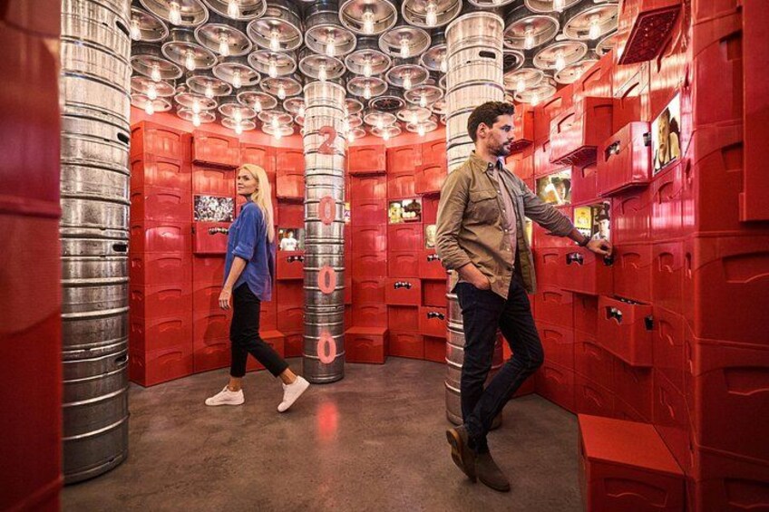 A metallic cylindrical structure with red lockers and a person walking inside. 5