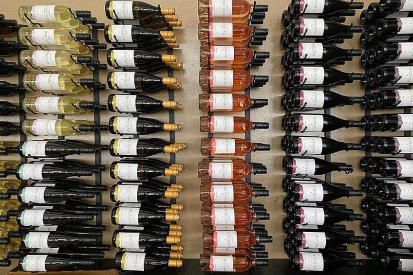 A collection of wine bottles arranged in rows on a wall. 4