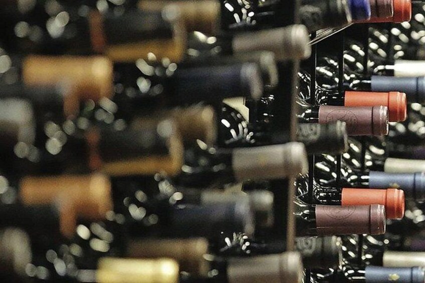 A close-up of wine bottles on a rack. 2