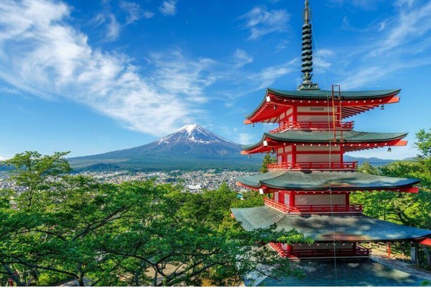 A red pagoda with a mountain in the background. 5