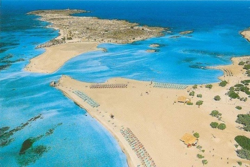 An aerial view of a coastal area with clear blue waters, sandy beaches, and scattered vegetation. 4