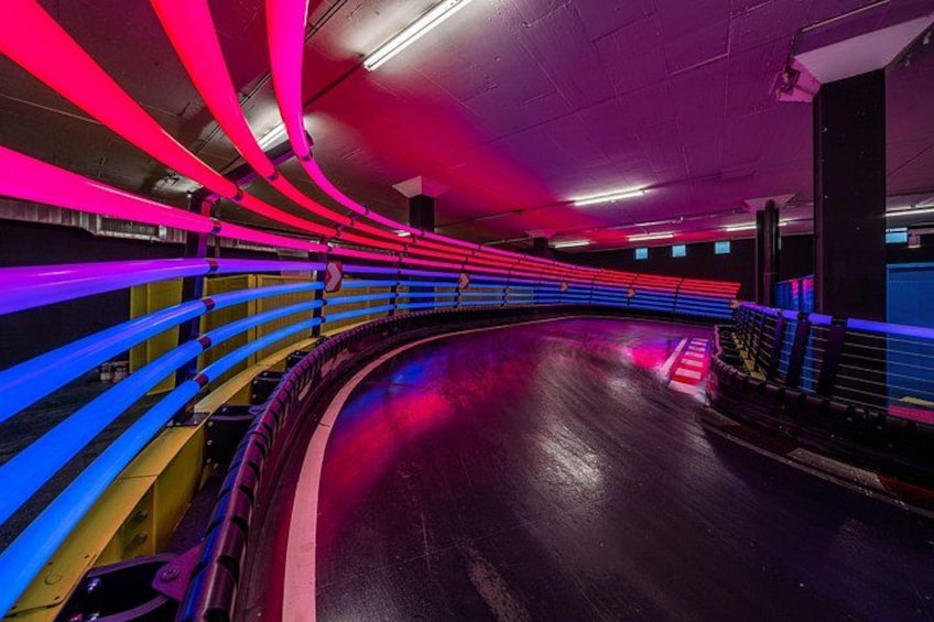 A curved tunnel with red and blue lighting. 3