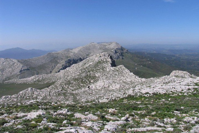 A mountainous landscape with rocky terrain and sparse vegetation. 2