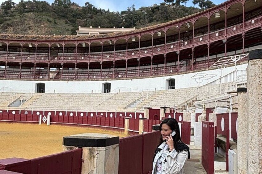 A bullfighting arena with tiered seating and a bullfight arena. 1