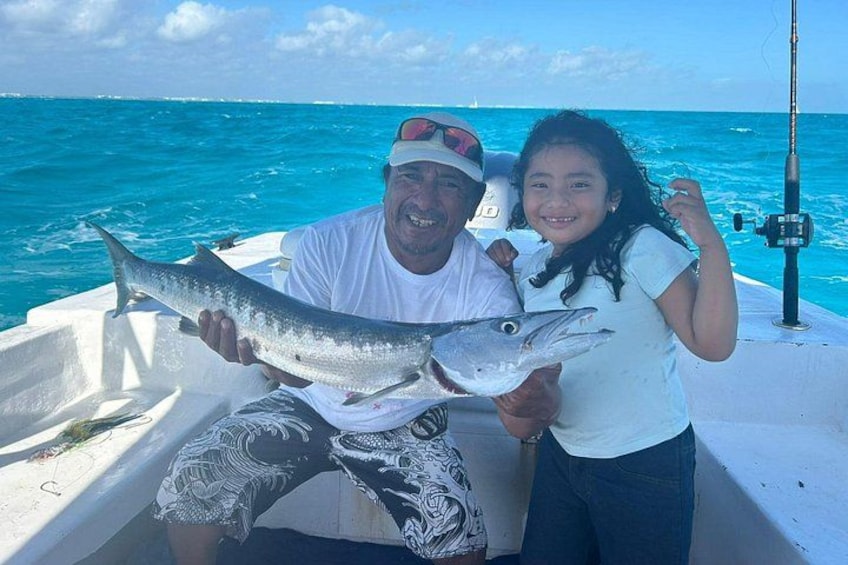 A boat on the water with a person holding a fish. 1