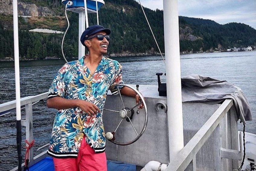 A person on a boat with a mountainous landscape in the background. 3