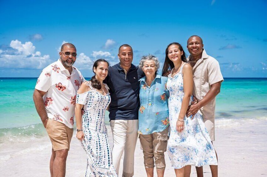 A group of people on a beach with clear turquoise water and a clear sky. 5