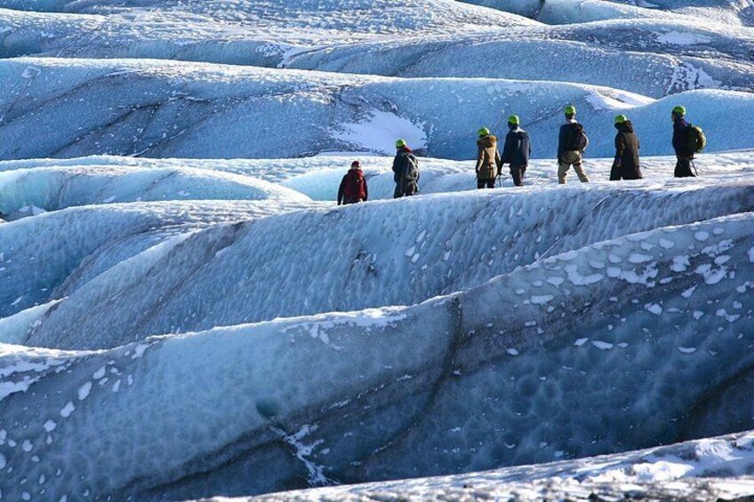 People hike across a glacier in Skaftafell, Iceland. 3