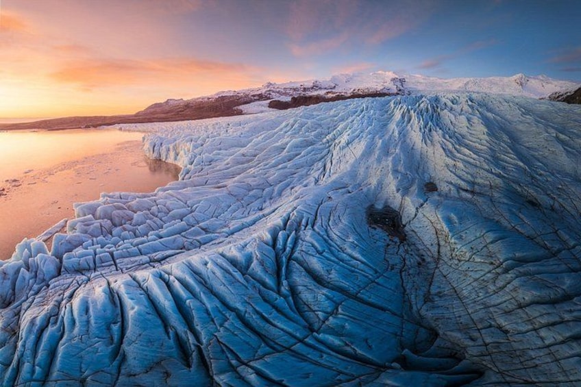 From above, an Icelandic glacier looks like a flowing river of ice with a rugged surface. 2