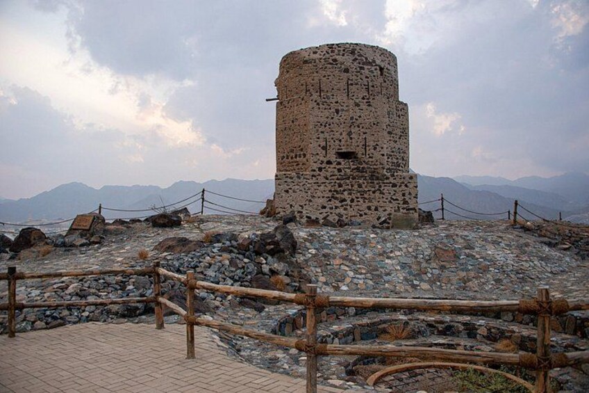 A stone tower with a rope barrier in a mountainous area. 2
