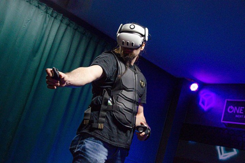 A person wearing a VR headset and holding a controller. 1