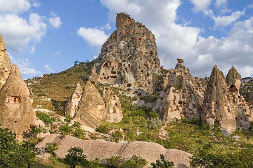 A landscape with unique rock formations and small cave dwellings. 2
