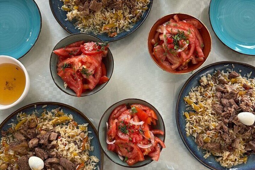 A variety of dishes including rice, meat, and vegetables on plates. 3