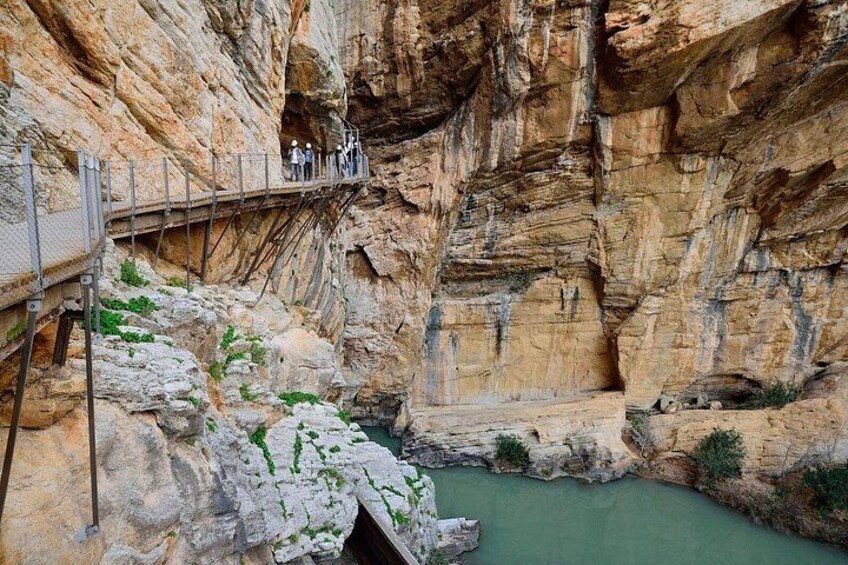 A rocky canyon with a viewing platform and a river. 2