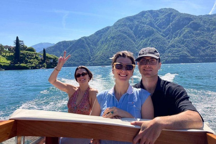 A boat on a lake with mountains in the background. 1