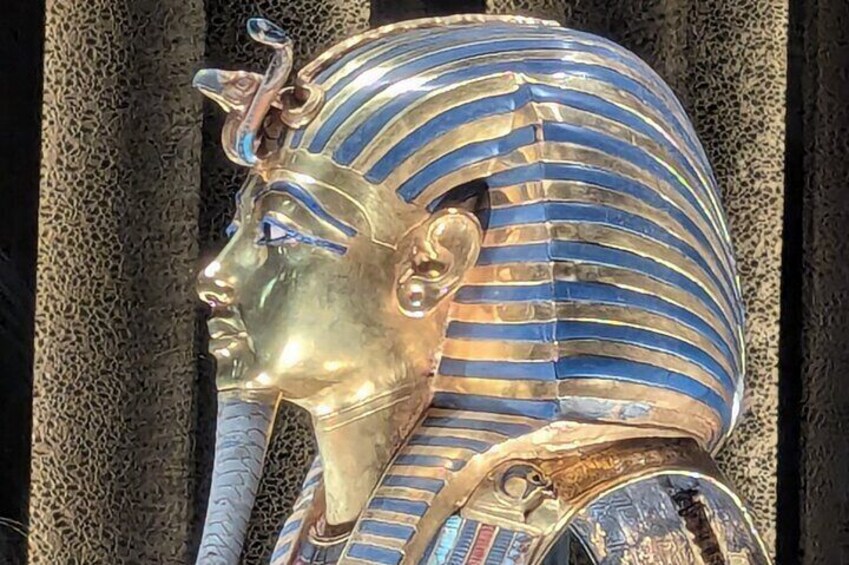 A golden bust with blue and gold striped headdress. 4