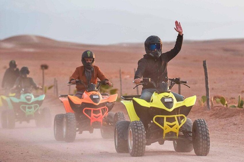Three off-road vehicles on a dusty road in a desert landscape. 4