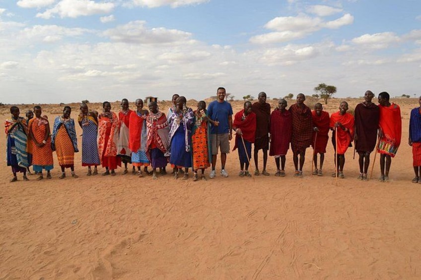 A group of people standing in a desert landscape. 5
