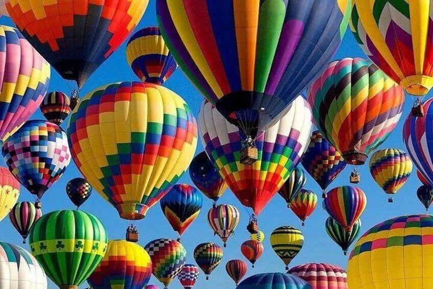 A variety of colorful hot air balloons against a clear blue sky. 2