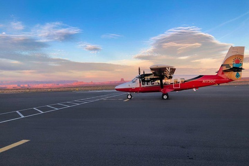 A red seaplane with registration N173GC on a runway. 2