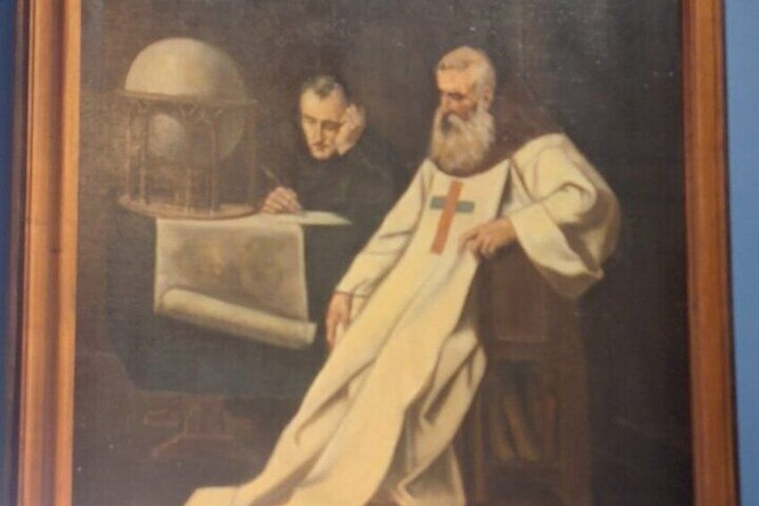 A painting of a man in religious attire writing at a desk with a globe and a book. 2