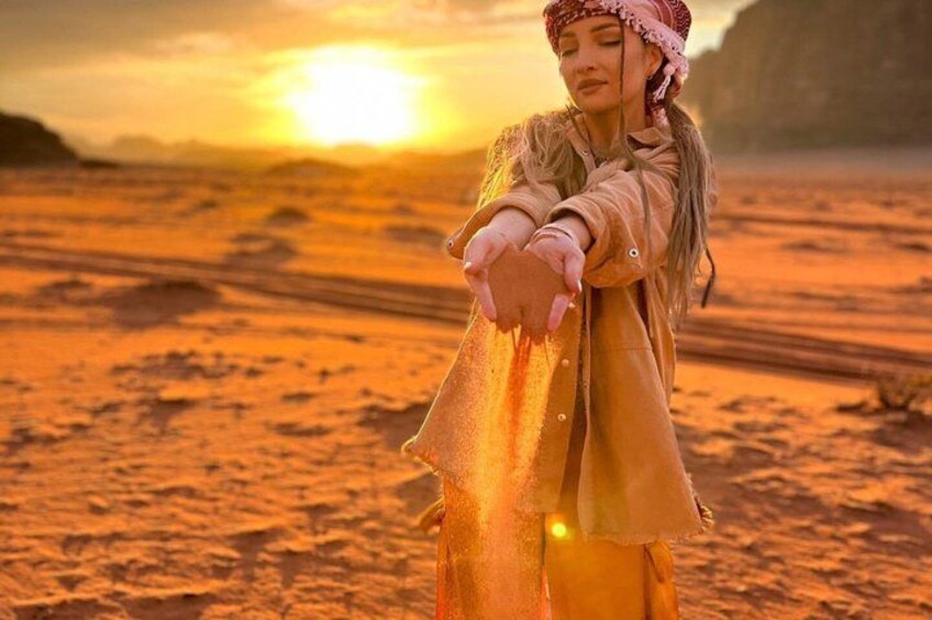 A person standing on a desert with a sunset in the background. 4