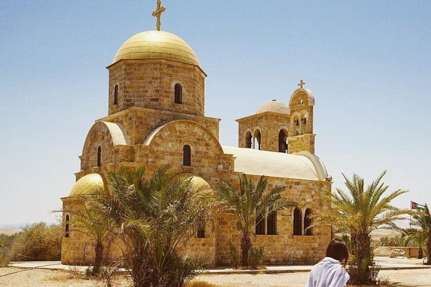 A stone church with a large dome and bell towers. 2