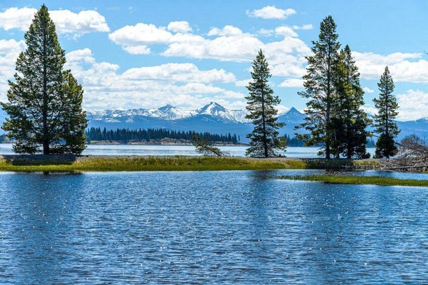 A lake with trees and mountains in the background. 5