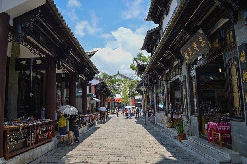 A traditional street with shops and pedestrians. 5