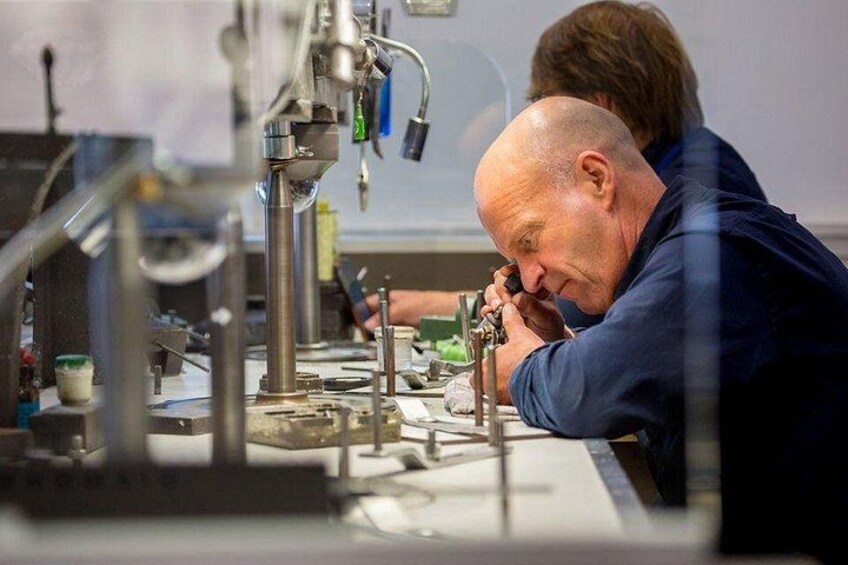 A person working with machinery, possibly in a laboratory or workshop setting. 4