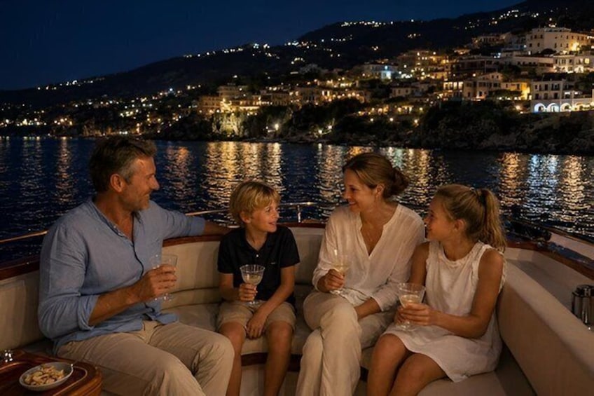 A group of people on a boat with a coastal town in the background. 1