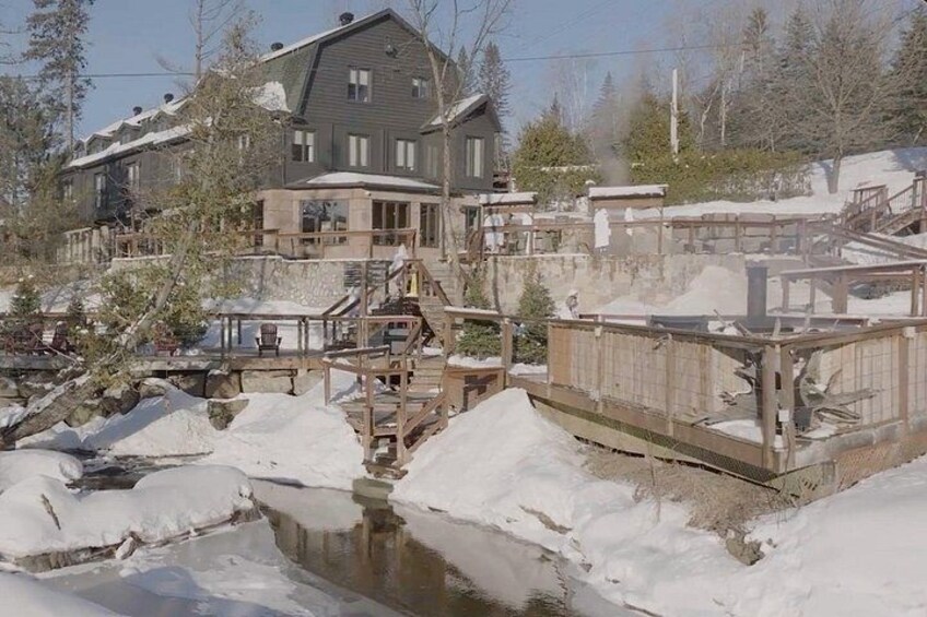 A residential area with a large house, wooden docks, and a frozen stream. 1