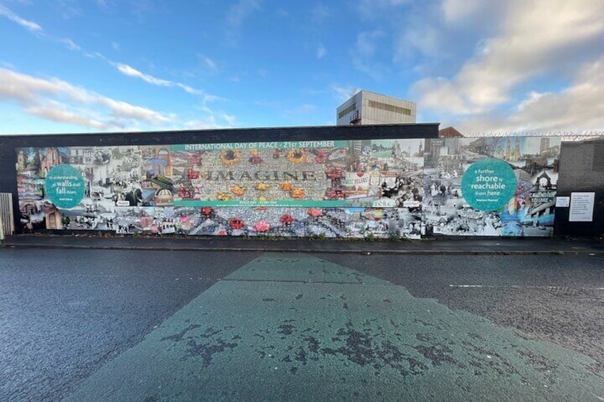 A mural on a wall with the text "INTERNATIONAL DAY OF PEACE - 21ST SEPTEMBER" and "walls out there". 5